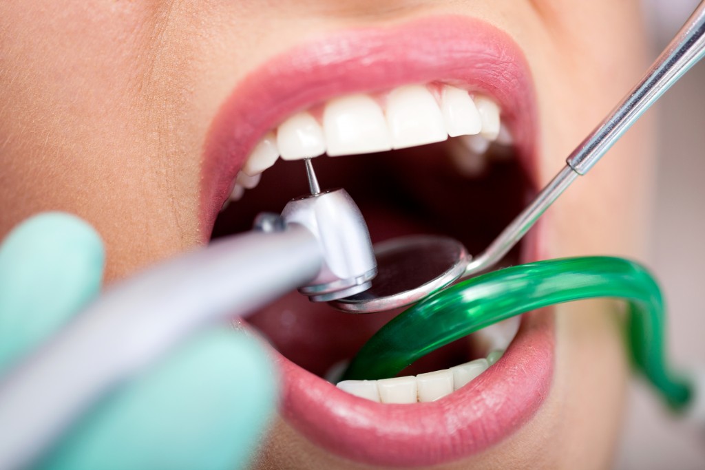 Close Up Of Dentist with Drill For Patients Teeth