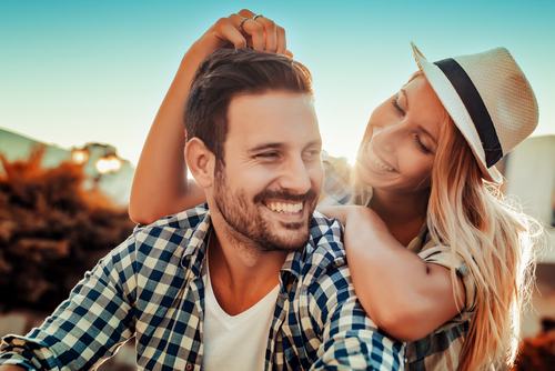 happy young couple smiling outdoors